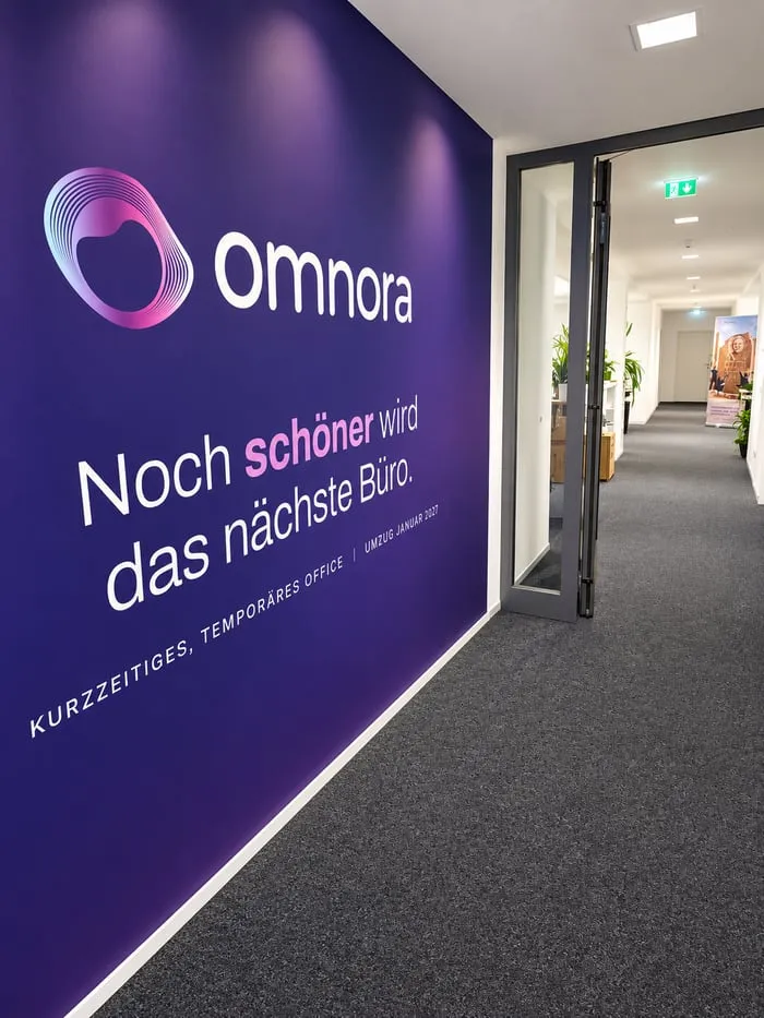 Entrance with a purple Omnora wall and a view down the hallway