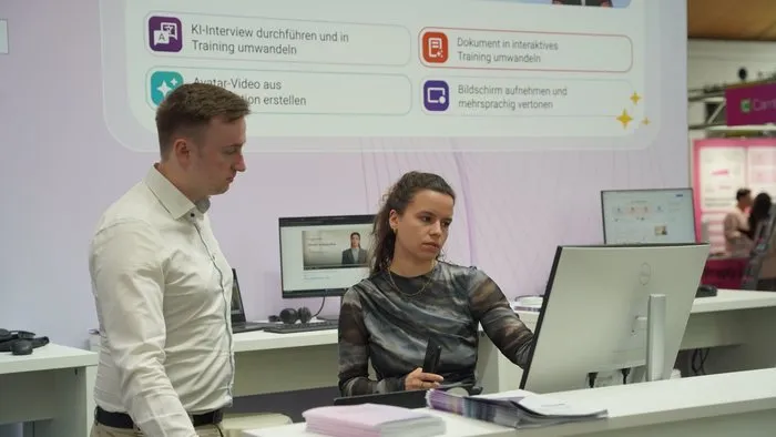 Two colleagues preparing a product demo at the trade fair stand