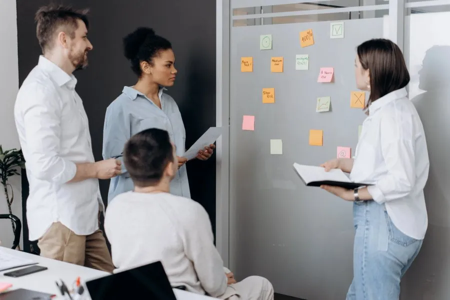 Team workshop at a wall full of sticky notes